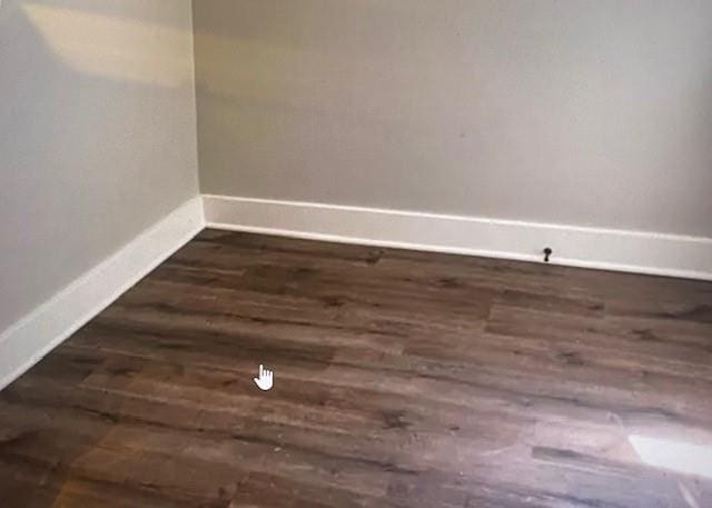 empty room with dark hardwood / wood-style floors