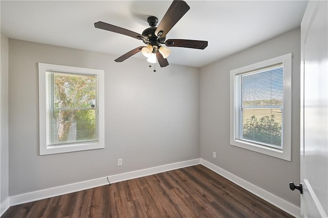 spare room featuring ceiling fan and dark wood-type flooring