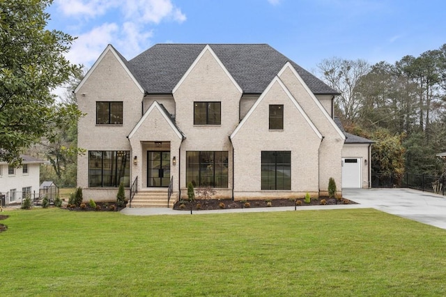 view of front of property with a garage and a front lawn