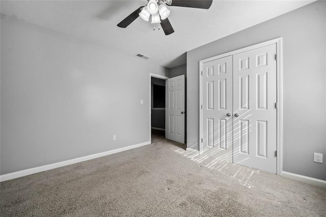 unfurnished bedroom featuring carpet floors, a closet, and ceiling fan