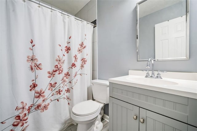 bathroom with a shower with curtain, vanity, and toilet