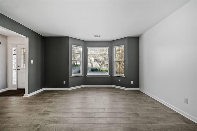 spare room with hardwood / wood-style floors