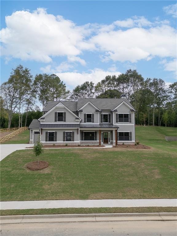 view of front of property featuring a garage and a front lawn