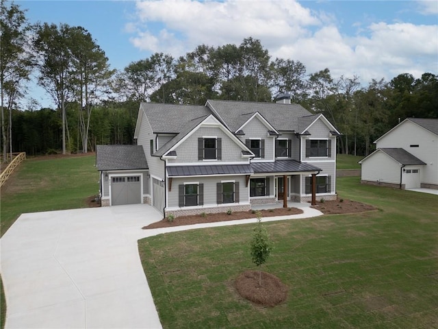 craftsman inspired home featuring a garage, a front yard, and covered porch