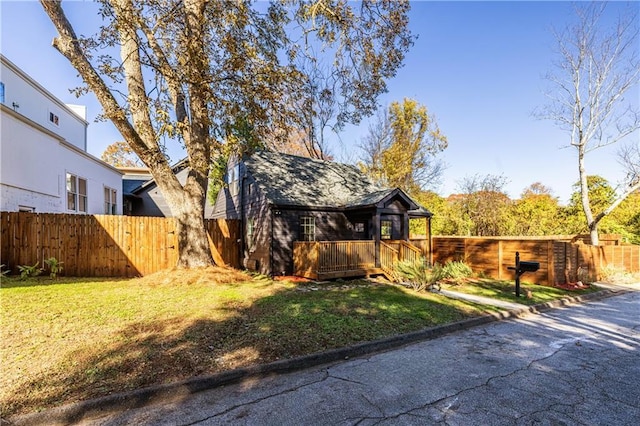 view of home's exterior with a lawn and a deck