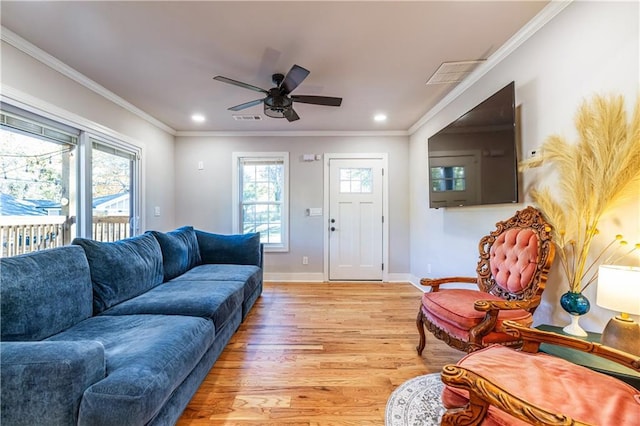 living room with light wood-type flooring, ceiling fan, and ornamental molding