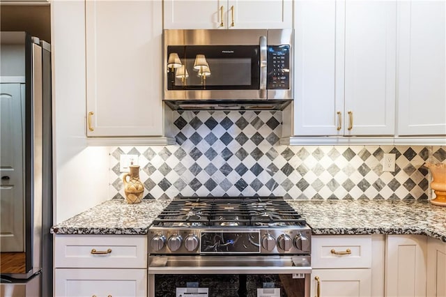 kitchen featuring light stone counters, appliances with stainless steel finishes, and tasteful backsplash