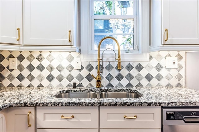 kitchen featuring white cabinets and light stone countertops