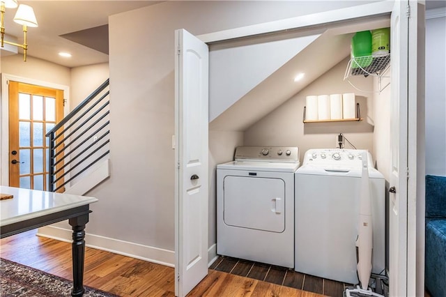 laundry area featuring washer and clothes dryer and dark hardwood / wood-style flooring