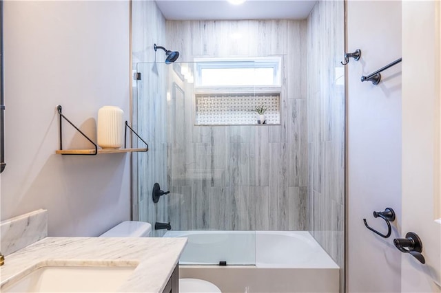 full bathroom with vanity, toilet, and shower / bath combination with glass door