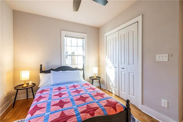 bedroom with hardwood / wood-style floors, ceiling fan, and a closet