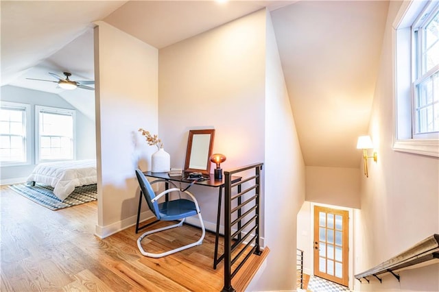 interior space with ceiling fan, hardwood / wood-style floors, and lofted ceiling