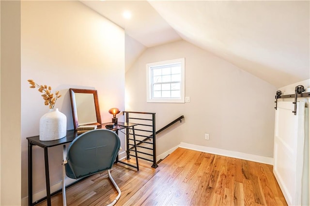 interior space with light hardwood / wood-style floors and lofted ceiling