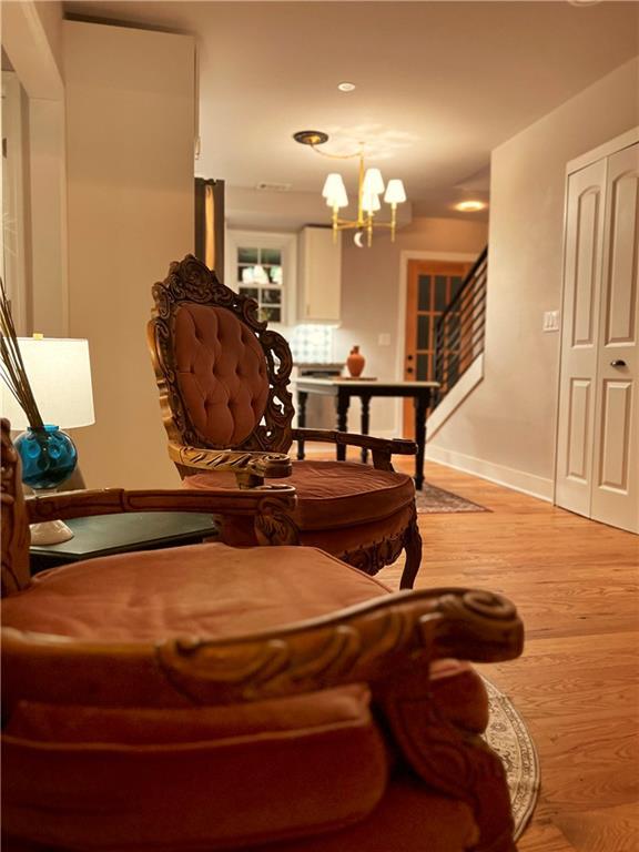 interior space featuring light hardwood / wood-style floors and an inviting chandelier