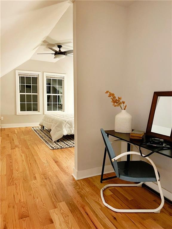 bedroom with wood-type flooring, ceiling fan, and lofted ceiling