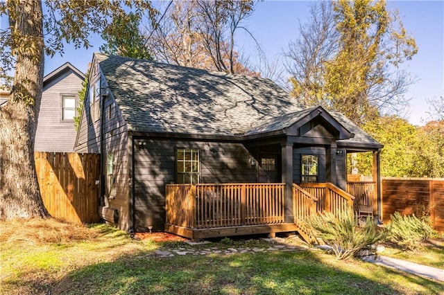 view of front of house featuring a front yard and a wooden deck