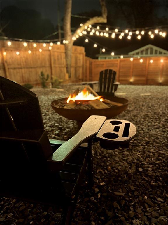 yard at night featuring a fire pit