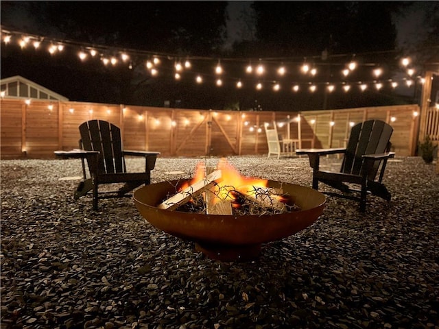 patio at twilight featuring an outdoor fire pit