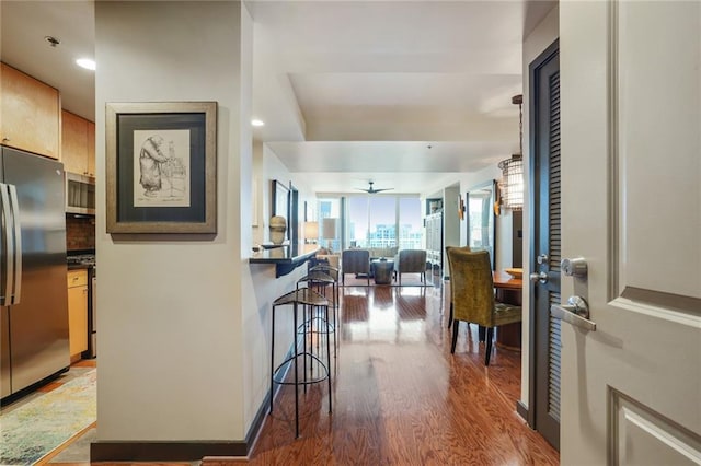 entrance foyer with wood finished floors and a ceiling fan