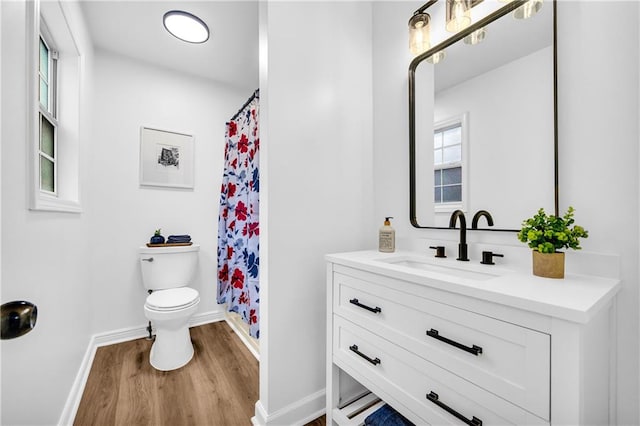 bathroom featuring toilet, wood finished floors, vanity, and a shower with curtain