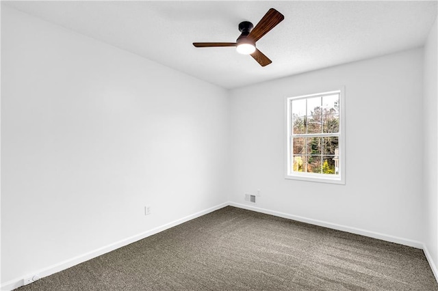 unfurnished room with a ceiling fan, visible vents, baseboards, and carpet flooring