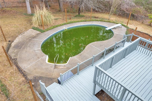 outdoor pool featuring a diving board