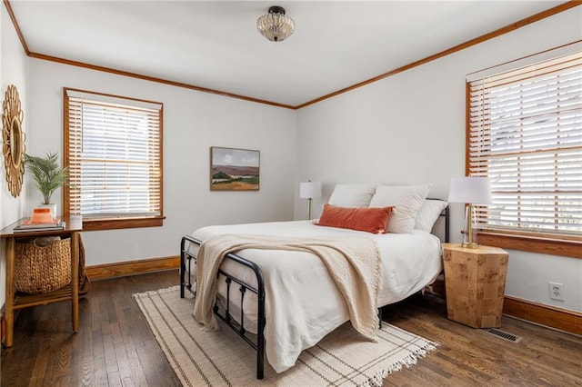 bedroom with ornamental molding, wood-type flooring, and multiple windows