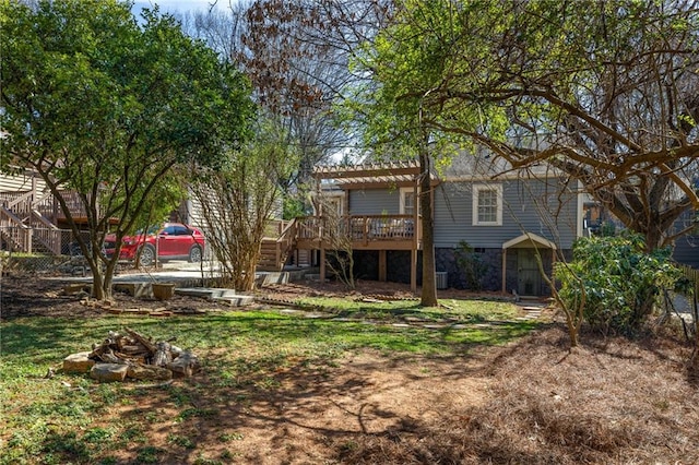 rear view of property featuring stone siding, stairway, a wooden deck, and a pergola