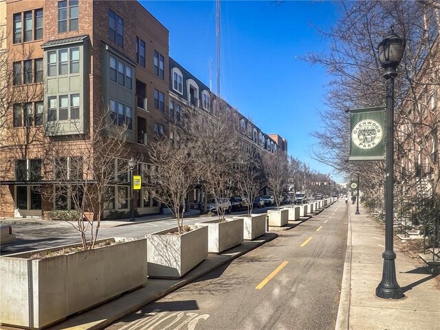 view of street featuring street lighting, curbs, and sidewalks