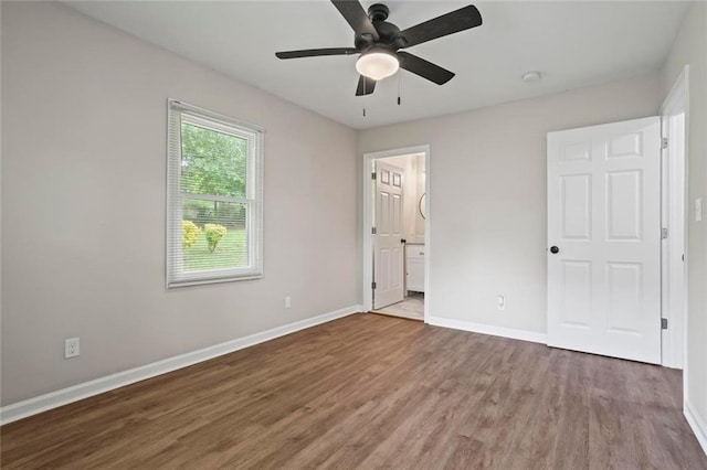 2478 Graywall St, East Point, GA 30344 - unfurnished bedroom featuring wood finished floors, baseboards, ensuite bath, and a ceiling fan