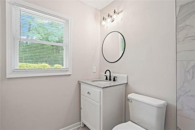2478 Graywall St, East Point, GA 30344 - bathroom with healthy amount of natural light, toilet, vanity, and baseboards