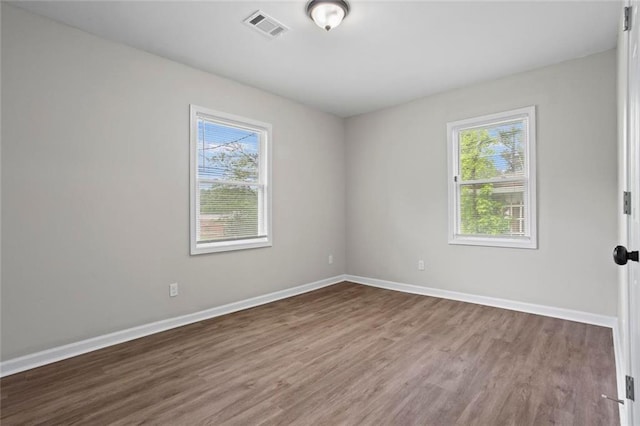 2478 Graywall St, East Point, GA 30344 - empty room with healthy amount of natural light, wood finished floors, and baseboards
