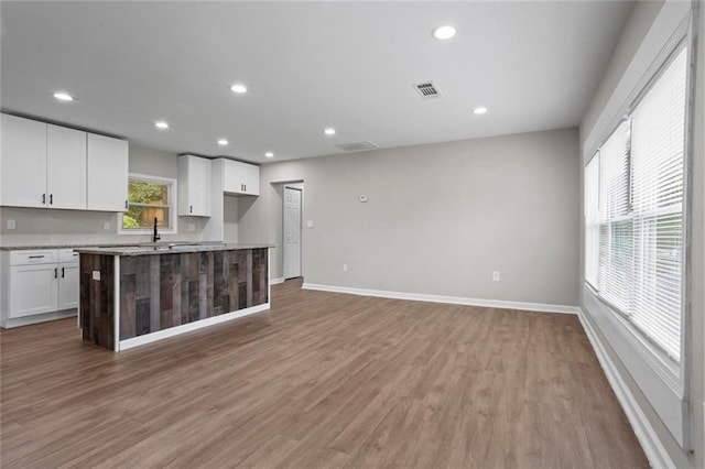 2478 Graywall St, East Point, GA 30344 - kitchen with white cabinetry, baseboards, light wood-style floors, recessed lighting, and a kitchen island