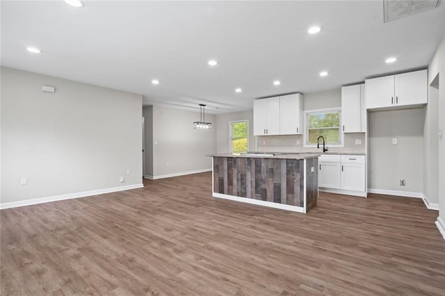 2478 Graywall St, East Point, GA 30344 - kitchen with a sink, white cabinetry, baseboards, recessed lighting, and a kitchen island