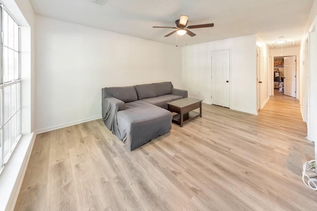 living room with light hardwood / wood-style floors and ceiling fan