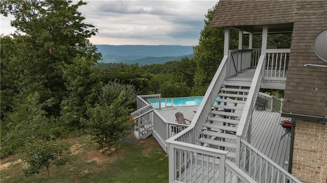 exterior space featuring a deck with mountain view