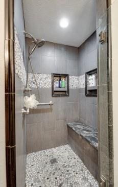 bathroom with a tile shower