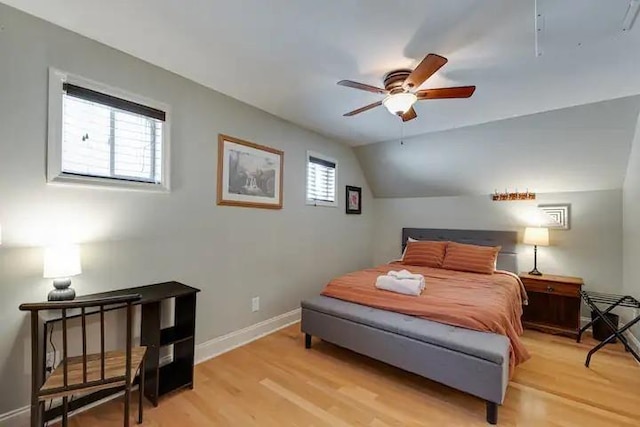 bedroom featuring light hardwood / wood-style flooring, ceiling fan, and lofted ceiling