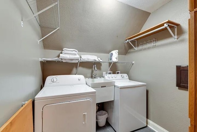 laundry room with washing machine and dryer and sink