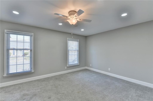 carpeted spare room featuring recessed lighting, baseboards, and ceiling fan