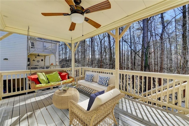 wooden deck featuring ceiling fan and an outdoor hangout area