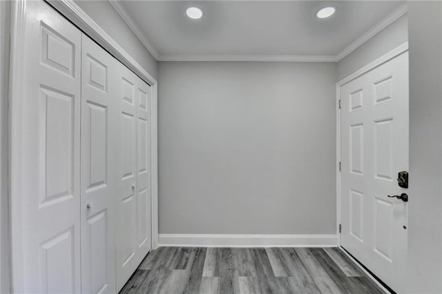 interior space featuring crown molding, recessed lighting, wood finished floors, and baseboards