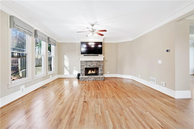 unfurnished living room featuring light wood-style floors, visible vents, a fireplace, and baseboards