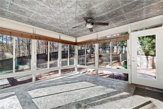 unfurnished sunroom with an ornate ceiling and a ceiling fan