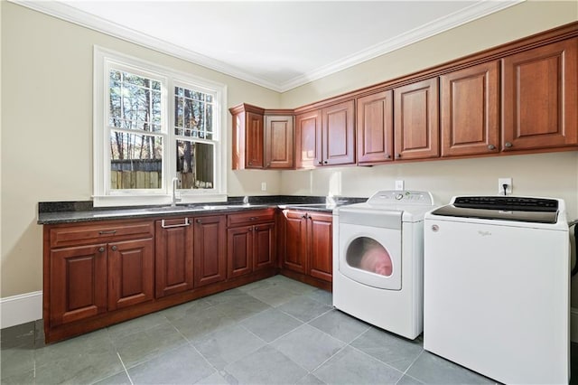 laundry area featuring cabinet space, light tile patterned floors, washer and clothes dryer, ornamental molding, and a sink