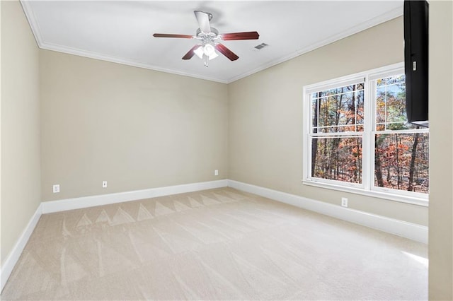 unfurnished room with ornamental molding, light colored carpet, and baseboards