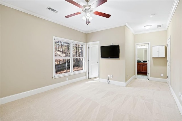 unfurnished living room with ornamental molding, light colored carpet, visible vents, and baseboards