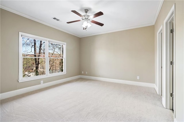 unfurnished bedroom with crown molding, light colored carpet, visible vents, ceiling fan, and baseboards