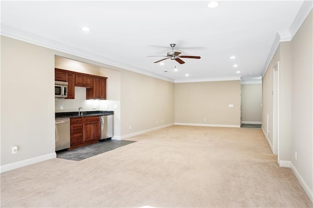 unfurnished living room with recessed lighting, light carpet, crown molding, and baseboards