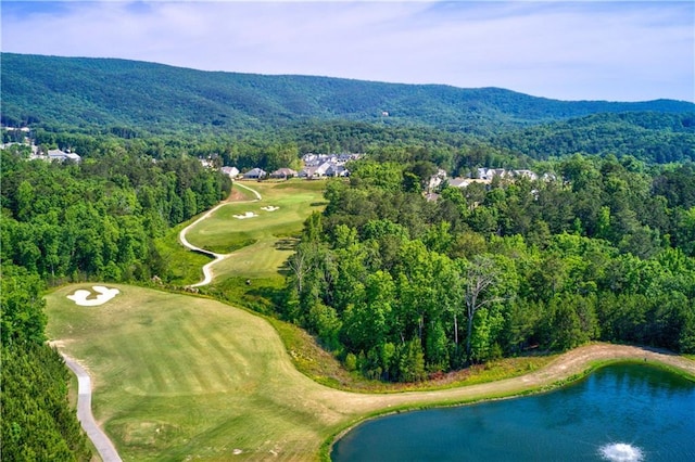 birds eye view of property with a wooded view, golf course view, and a water and mountain view